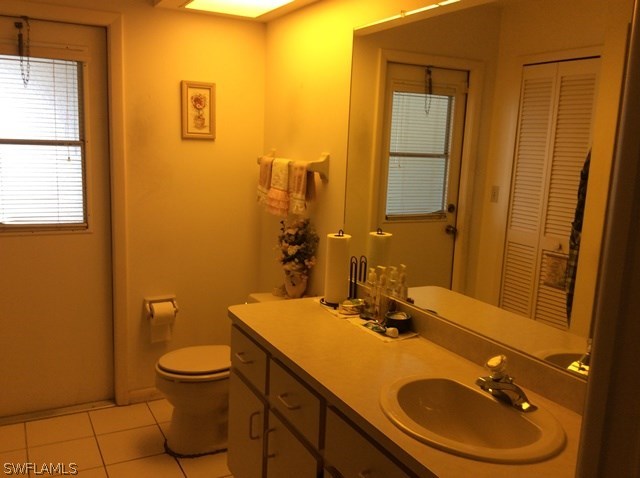 225 Danby Road Lehigh Acres, FL 33936 - Photo 17 of 20 a bathroom with a sink a toilet and mirror