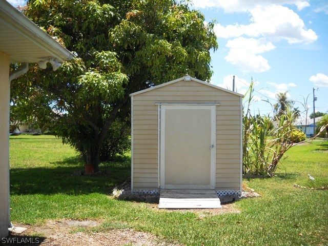 225 Danby Road Lehigh Acres, FL 33936 - Photo 19 of 20 a front view of a house with a yard