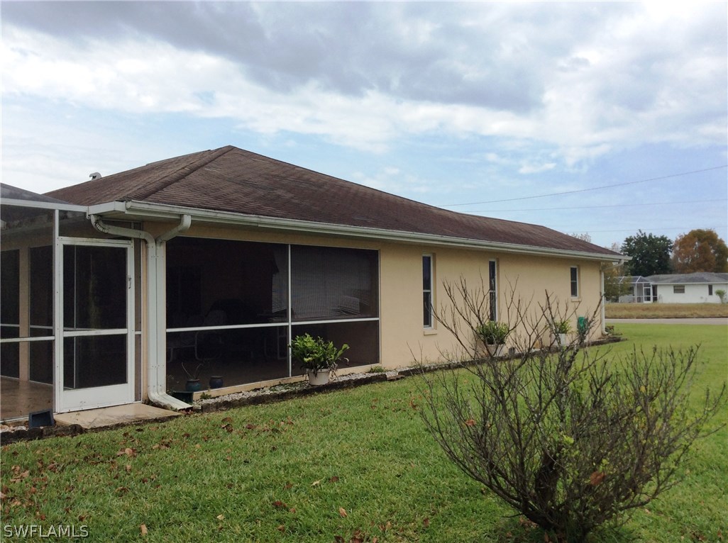 225 Danby Road Lehigh Acres, FL 33936 - Photo 6 of 20 a backyard of a house with lots of green space