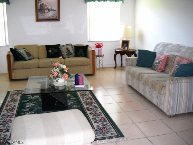 225 Danby Road Lehigh Acres, FL 33936 - Photo 9 of 20 a living room with furniture and a rug