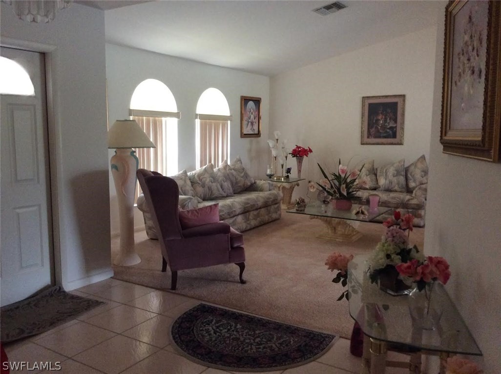 225 Danby Road Lehigh Acres, FL 33936 - Photo 10 of 20 a living room with furniture and a potted plant