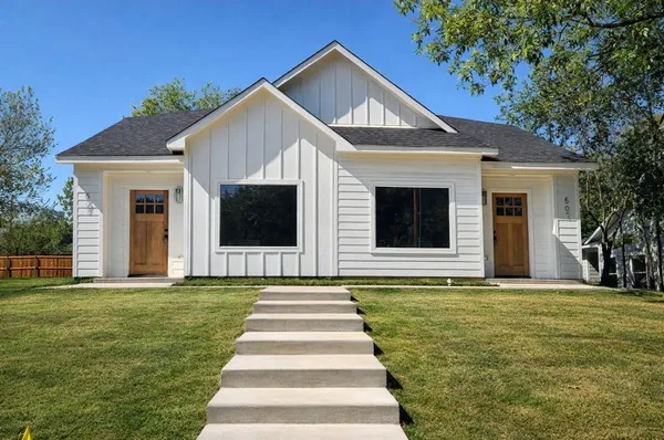 a front view of a house with a yard