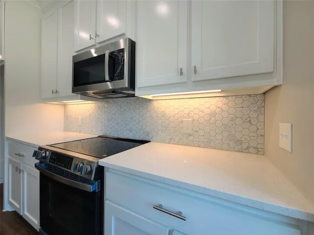 a kitchen with a stove and a microwave