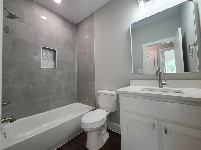 a bathroom with a toilet a sink and bathtub