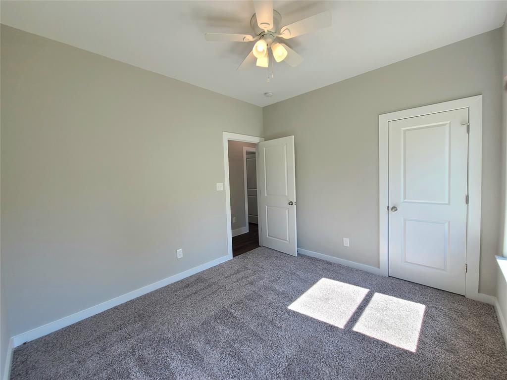 507 Northeast 5th Avenue Durant, OK 74701 - Photo 30 of 35 an empty room with closet and a chandelier fan