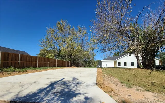 a view of white house with a yard