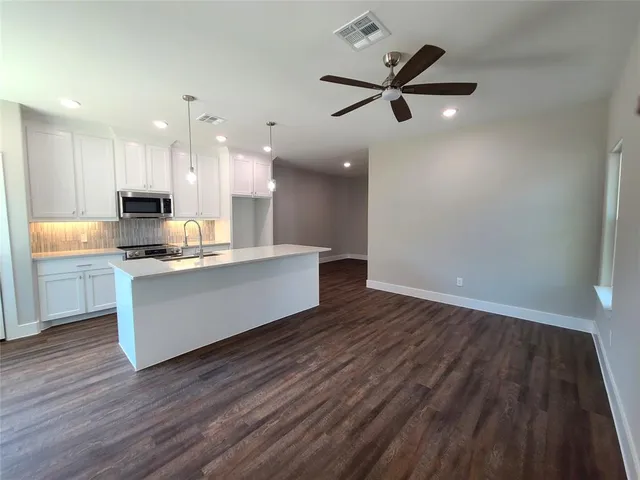 a view of kitchen with cabinets and wooden floor