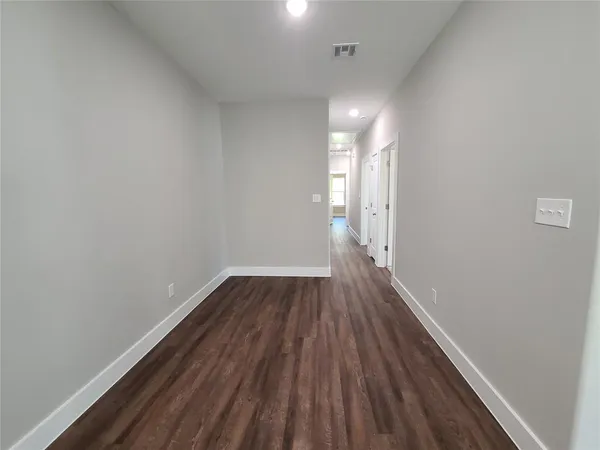 a view of a room with wooden floor and window