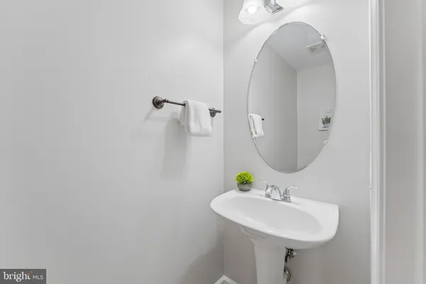 a bathroom with a sink a mirror and vanity