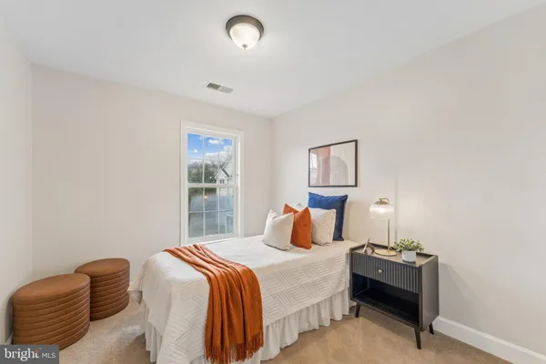 a bedroom with a bed and window