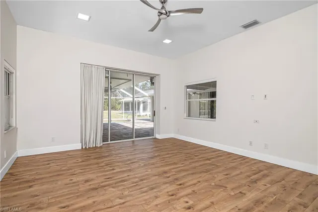 a bathroom with a granite countertop sink a mirror and a bathtub