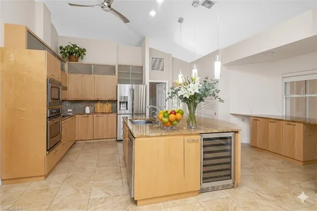 a kitchen with a sink refrigerator and cabinets