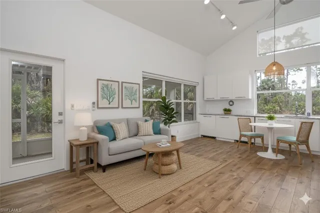 a kitchen with granite countertop white cabinets and a window