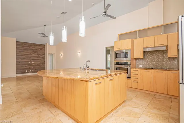 a kitchen with stainless steel appliances granite countertop a sink and cabinets