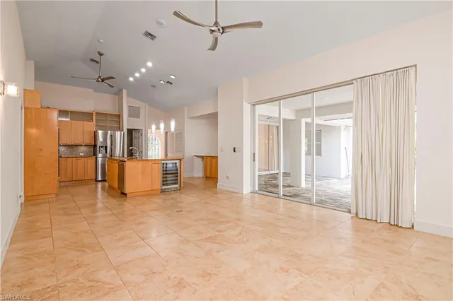 a view of a livingroom with a flat screen tv and refrigerator