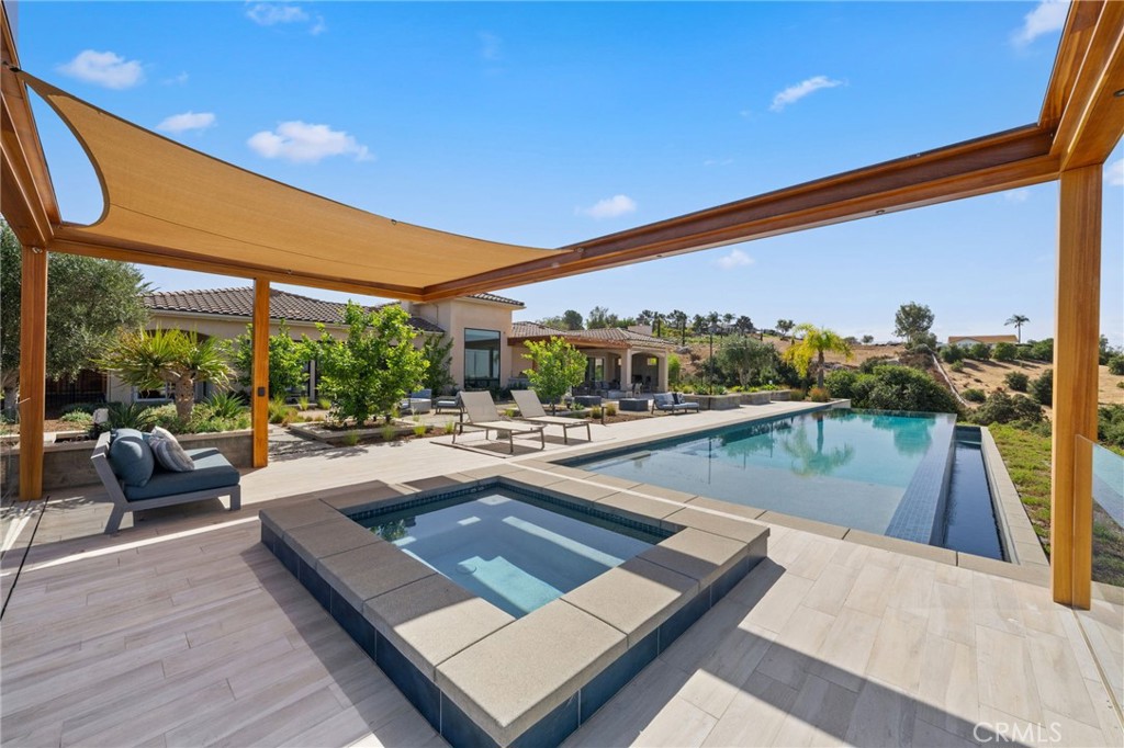 39893 Calle Breve Temecula, CA 92592 - Photo 44 of 70 a view of a swimming pool with a patio