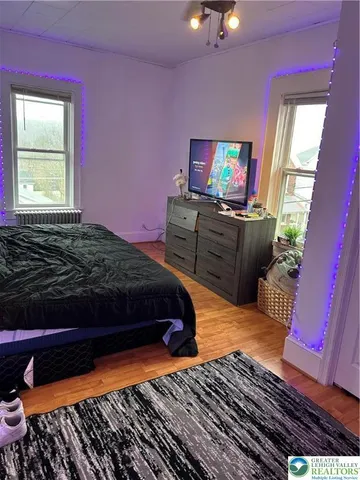 a bedroom with a bed and flat screen tv