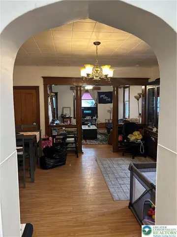a living room with furniture and a chandelier
