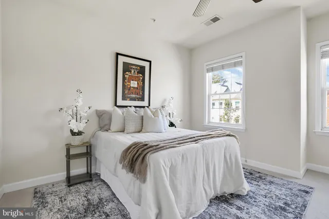 a bedroom with a bed and a window