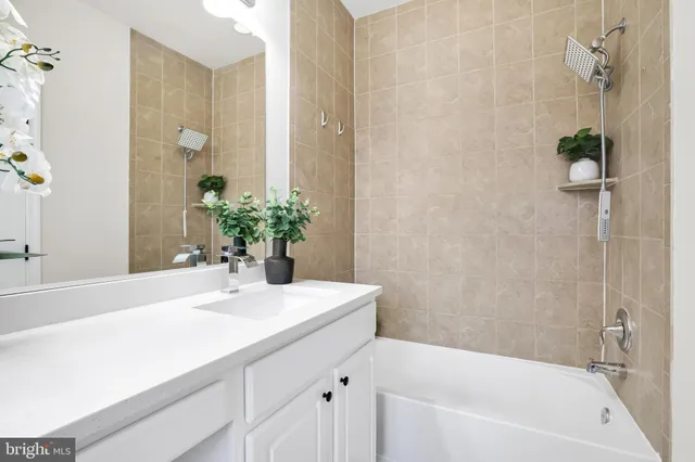 a bathroom with a sink a bathtub and a mirror
