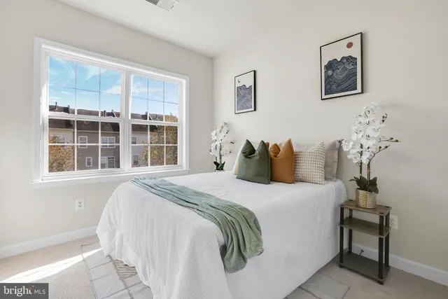 a bedroom with a bed and a window