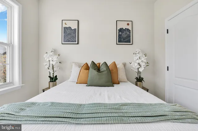 a bedroom with a bed and a window