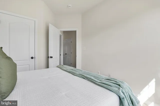 a bedroom with a bed and a mirror