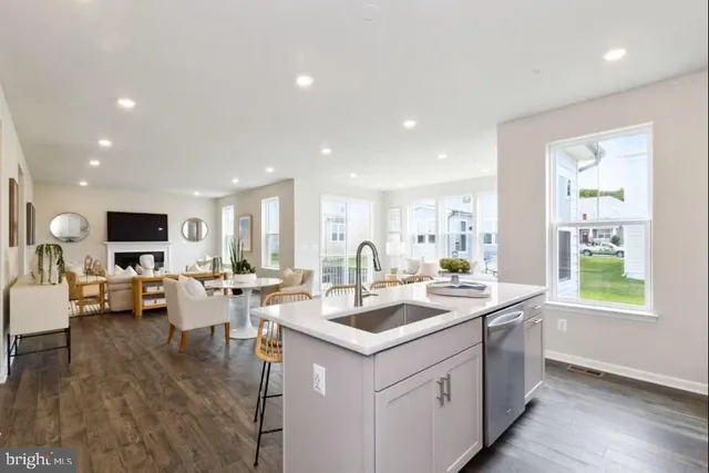 a dining room with furniture potted plants and wooden floor