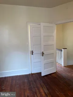 a view of an empty room and wooden floor