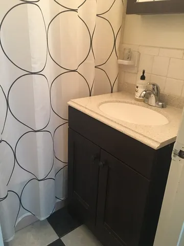a bathroom with a sink and mirror