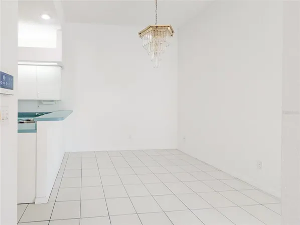 a kitchen with kitchen island a sink a stove and white cabinets