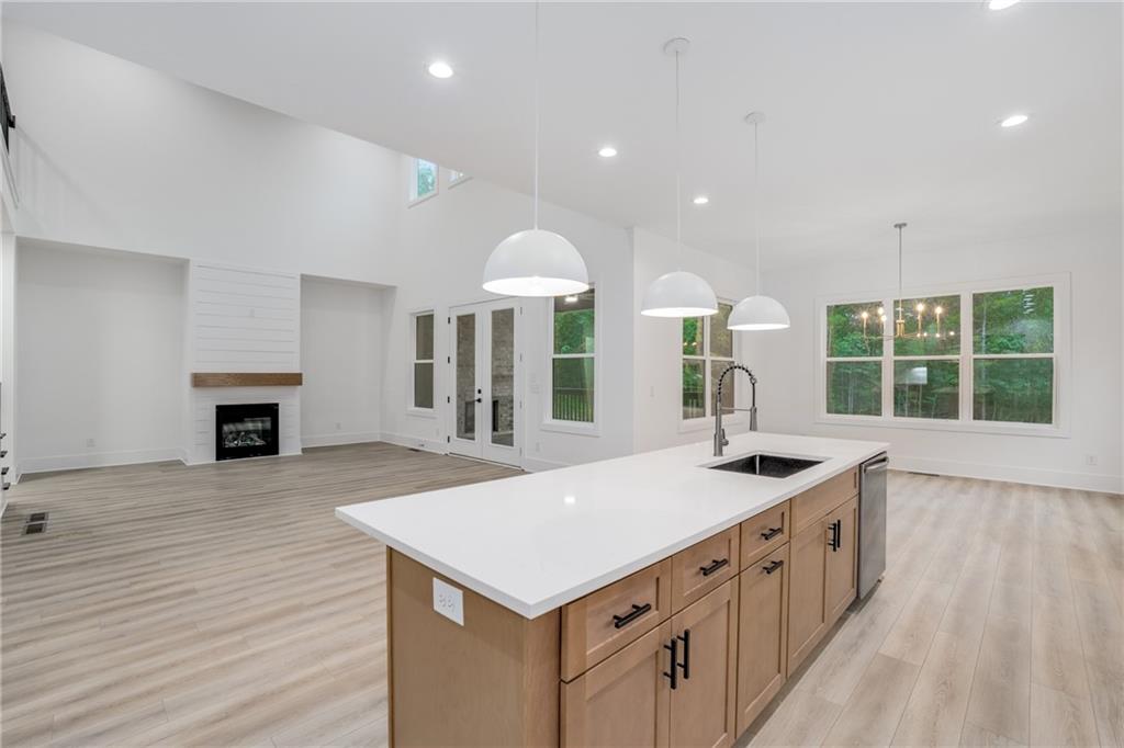 3766 Cheyenne Lane Jefferson, GA 30549 - Photo 12 of 52 an open kitchen with a sink and dishwasher with wooden floor