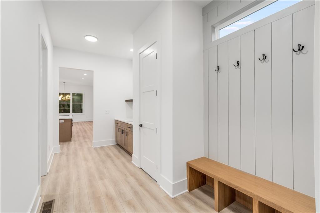 3766 Cheyenne Lane Jefferson, GA 30549 - Photo 16 of 52 a view of a hallway with wooden floor and staircase