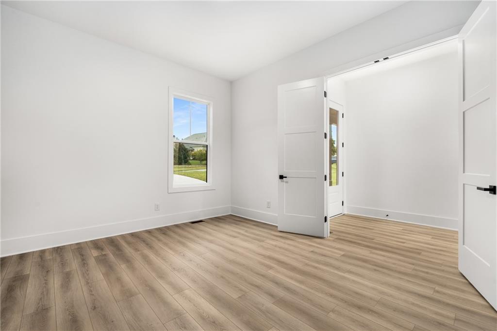 3766 Cheyenne Lane Jefferson, GA 30549 - Photo 20 of 52 an empty room with wooden floor and windows
