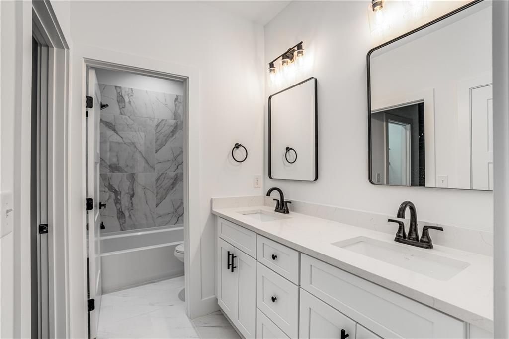 3766 Cheyenne Lane Jefferson, GA 30549 - Photo 34 of 52 a bathroom with a shower sink and mirror