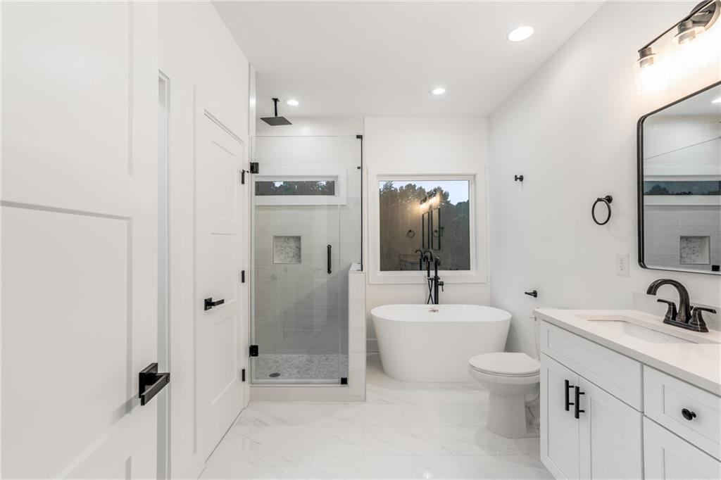 3766 Cheyenne Lane Jefferson, GA 30549 - Photo 37 of 52 a bathroom with a toilet sink mirror and shower