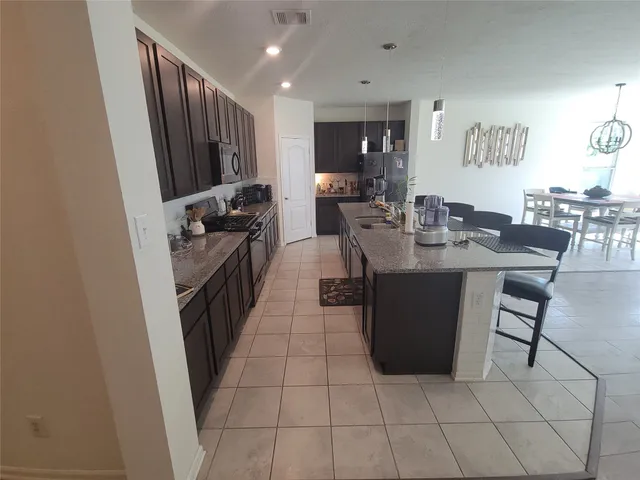 a kitchen with a sink a counter top space and stainless steel appliances