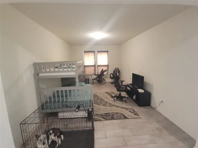 a bedroom with furniture and a window