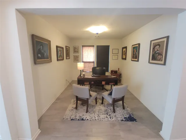 a work room with furniture and wooden floor