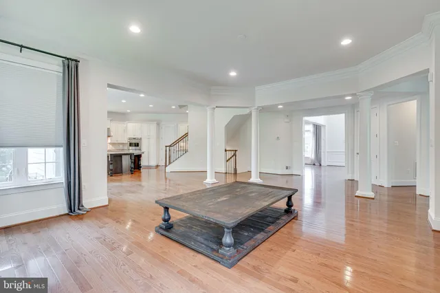 a living room with furniture fireplace and a large window