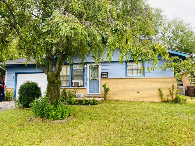 front view of a house with a tree