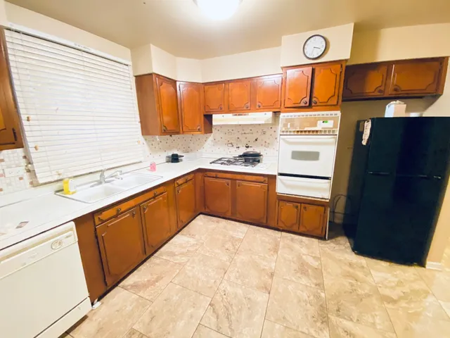 a kitchen with stainless steel appliances a sink and a refrigerator