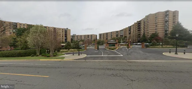 a view of a tall building next to a road