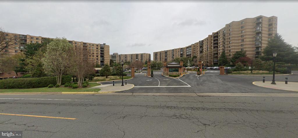 a view of a tall building next to a road