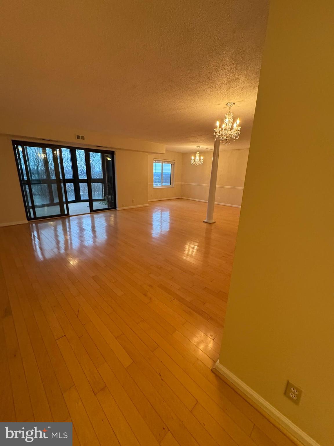 8370 Greensboro Drive, Unit 806 McLean, VA 22102 - Photo 23 of 31 a view of empty room with floor to ceiling window and wooden floor