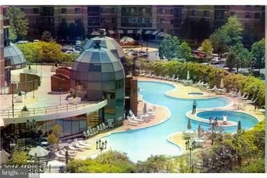 a view of a swimming pool with outdoor seating