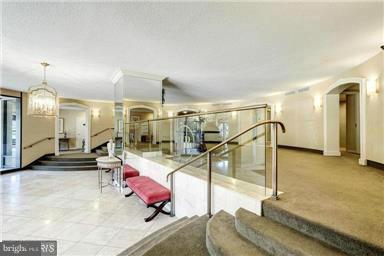 8370 Greensboro Drive, Unit 806 McLean, VA 22102 - Photo 5 of 31 a room with lots of white furniture and a chandelier
