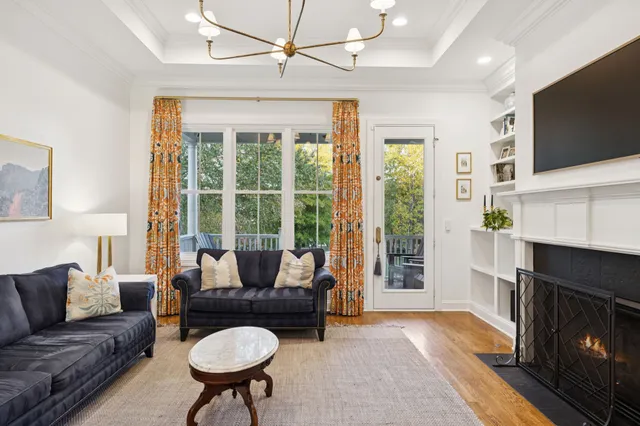 a living room with furniture and kitchen view