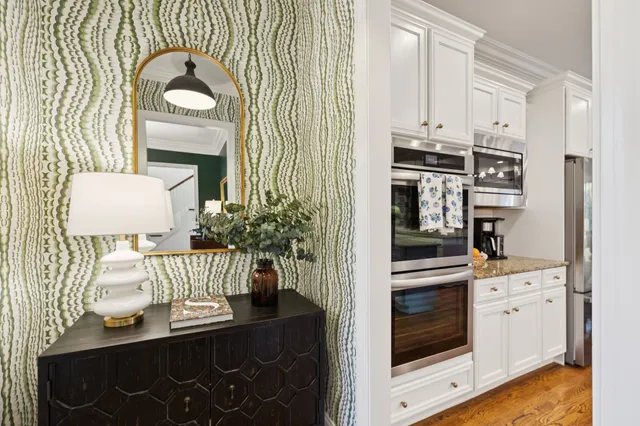 a large kitchen with kitchen island a large counter space a sink appliances and living room view