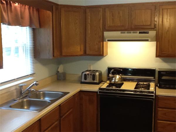 32 Haskell Road Pepperell, MA 01463 - Photo 4 of 18 a kitchen with a sink a stove cabinets and a window